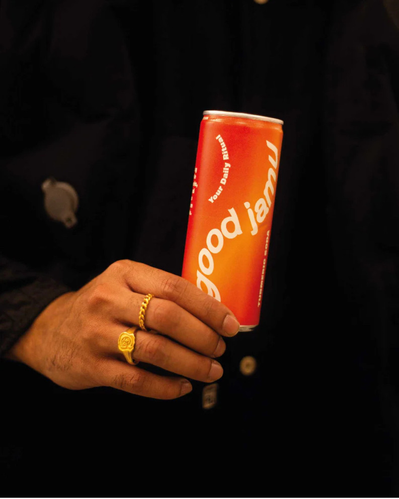 Person holding Good Jamu's turmeric soda can