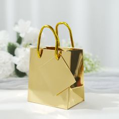 [About] Quantity: 12 Gift Bags Material: Paper Color: Metallic Gold Bag Height: 4.75" Bag Width: 2.75" Bag Length: 4" Handle Length: 5" Tag Size: 2.4"L x 2.75"W Features: Premium paper, lightweight, durable, reusable Sturdy metallic rope handles ensure comfortable and stylish carry [Information] Additional Information: Listing is for Gift Bags & Tags only. Other decorative accessories are not included Perfect for holding gifts such as candles, figurines, books, video games, CDs, etc. Uses: Weddi