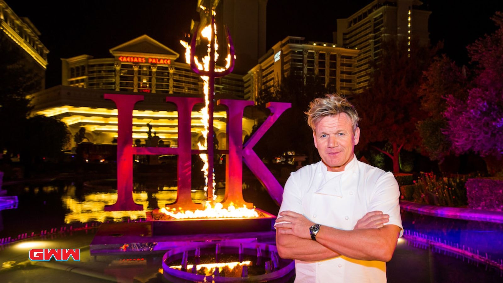 Gordon Ramsay standing confidently at Hell's Kitchen entrance, night scene