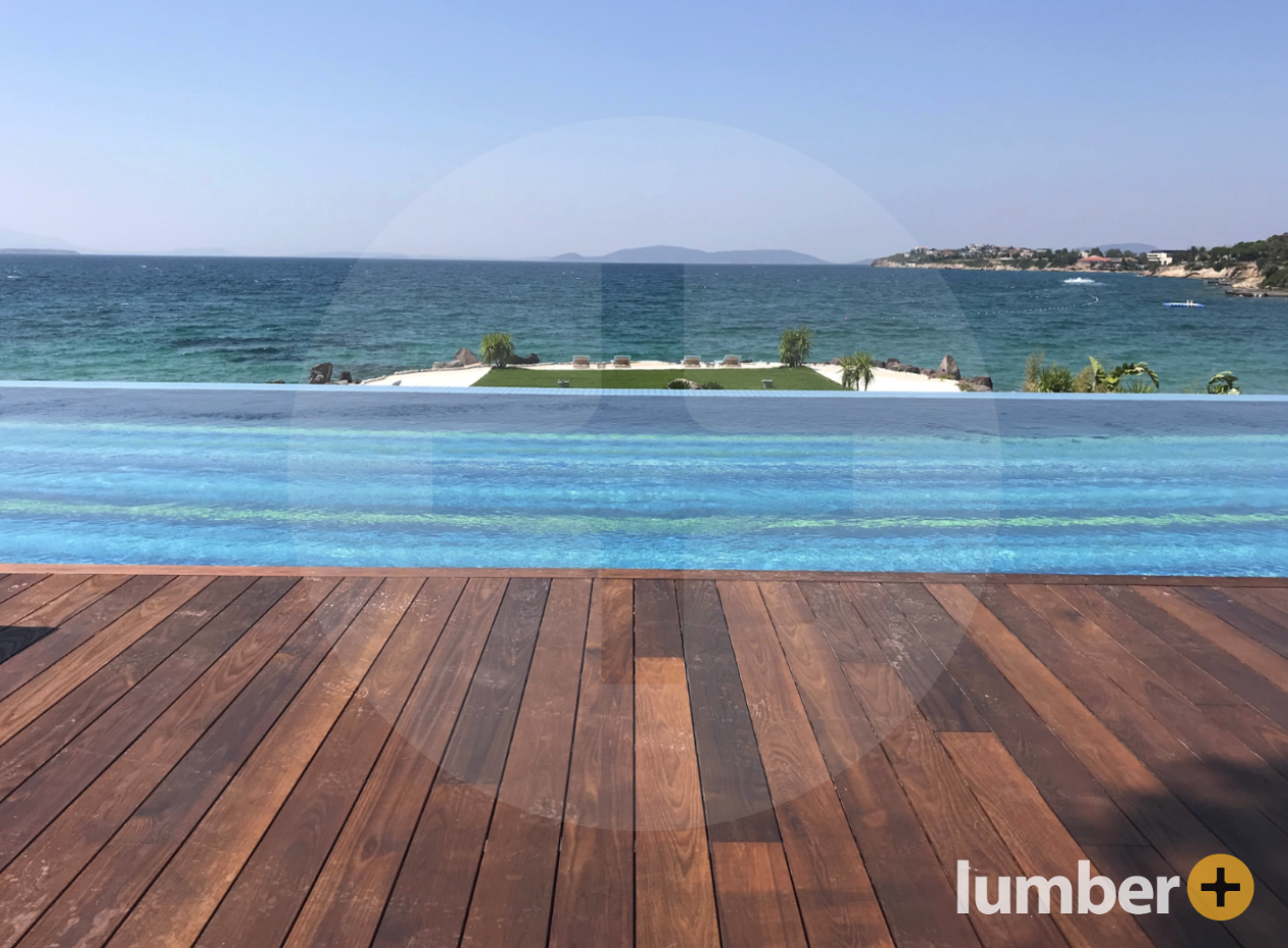 an image of a Thermowood® deck that overlooks a pool and the ocean