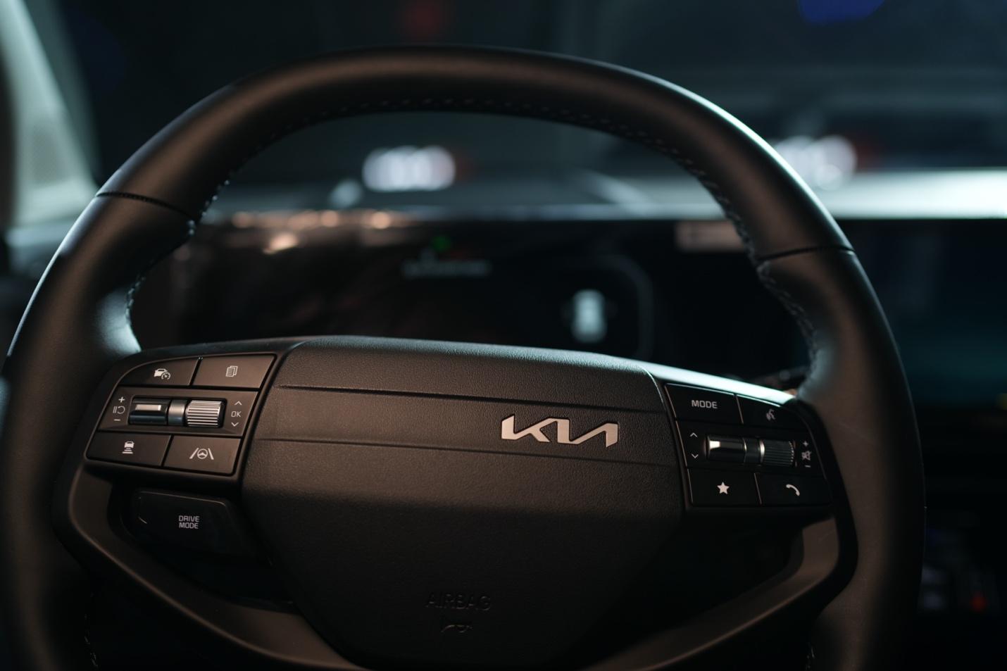 A close-up of a steering wheel  Description automatically generated