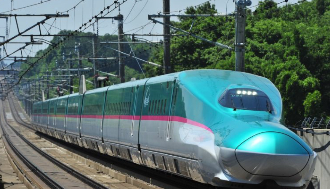 Shinkansen Train in transit on a bright day 