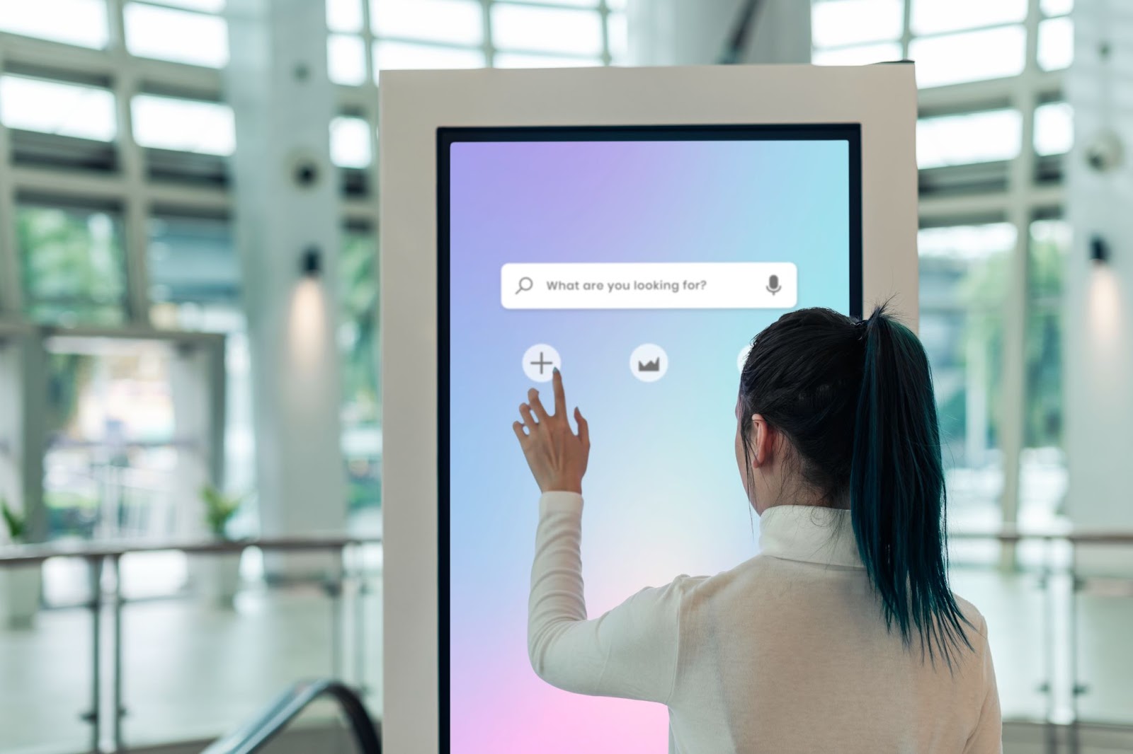 A woman interacting with a digital OOH ad