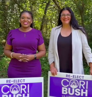 Rashida and Cori pose with Re-elect Cori Bush yardsigns