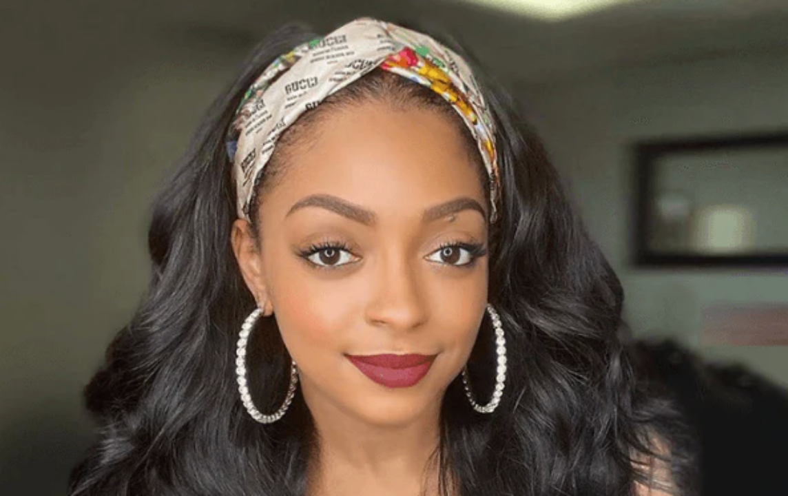 
Close-up of a headband wig featuring bouncy curls and a stylish floral headband.