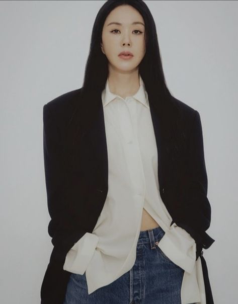 This contains an image of Uhm Jung Hwa on jean pant, white shirt and a black suit 