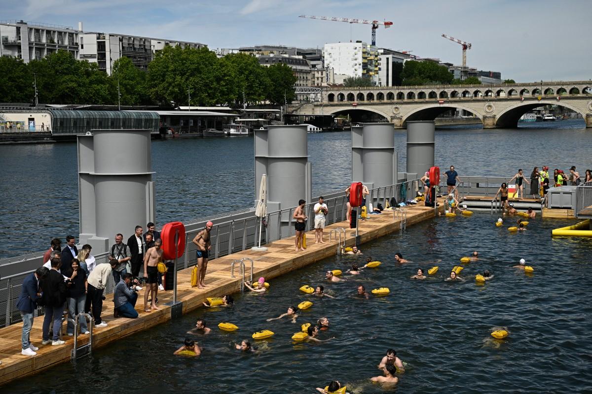 People swimming in a body of water

Description automatically generated
