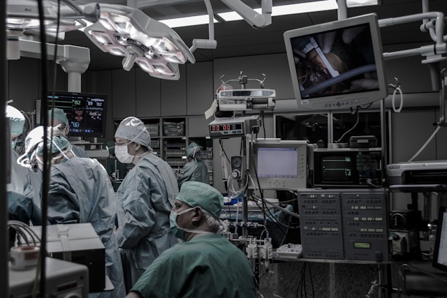 In an operating room, where ergonomic hospital design ensures staff efficiency, a team of focused surgeons performs a procedure.