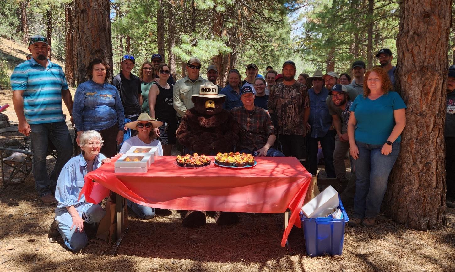 A group of people around a table with food on it

Description automatically generated