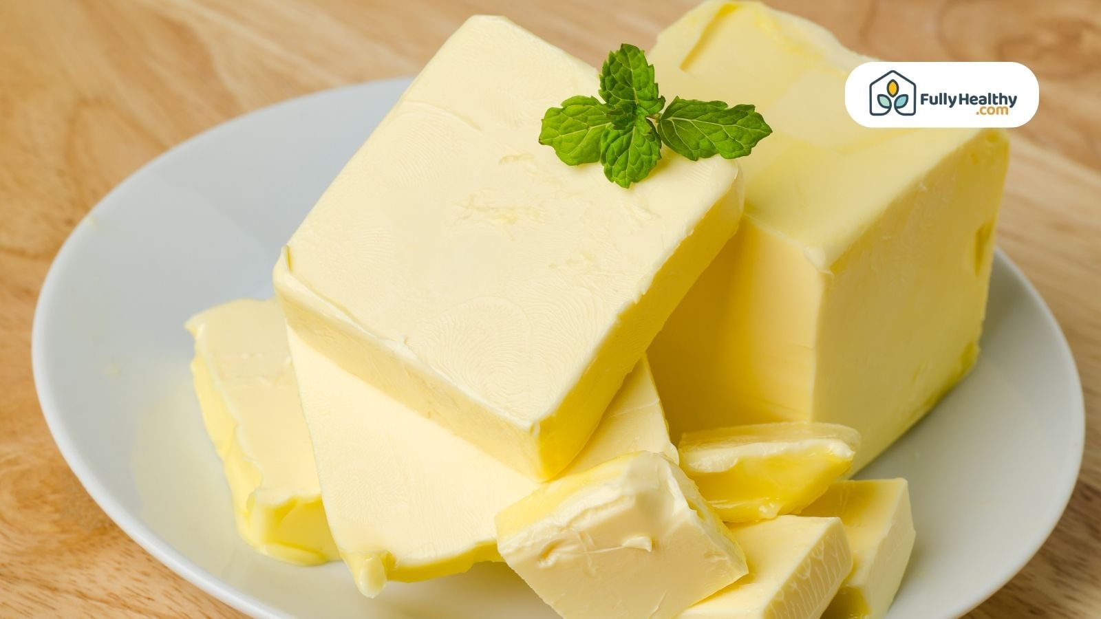 Butter cubes on a white plate with mint garnish FullyHealthy logo