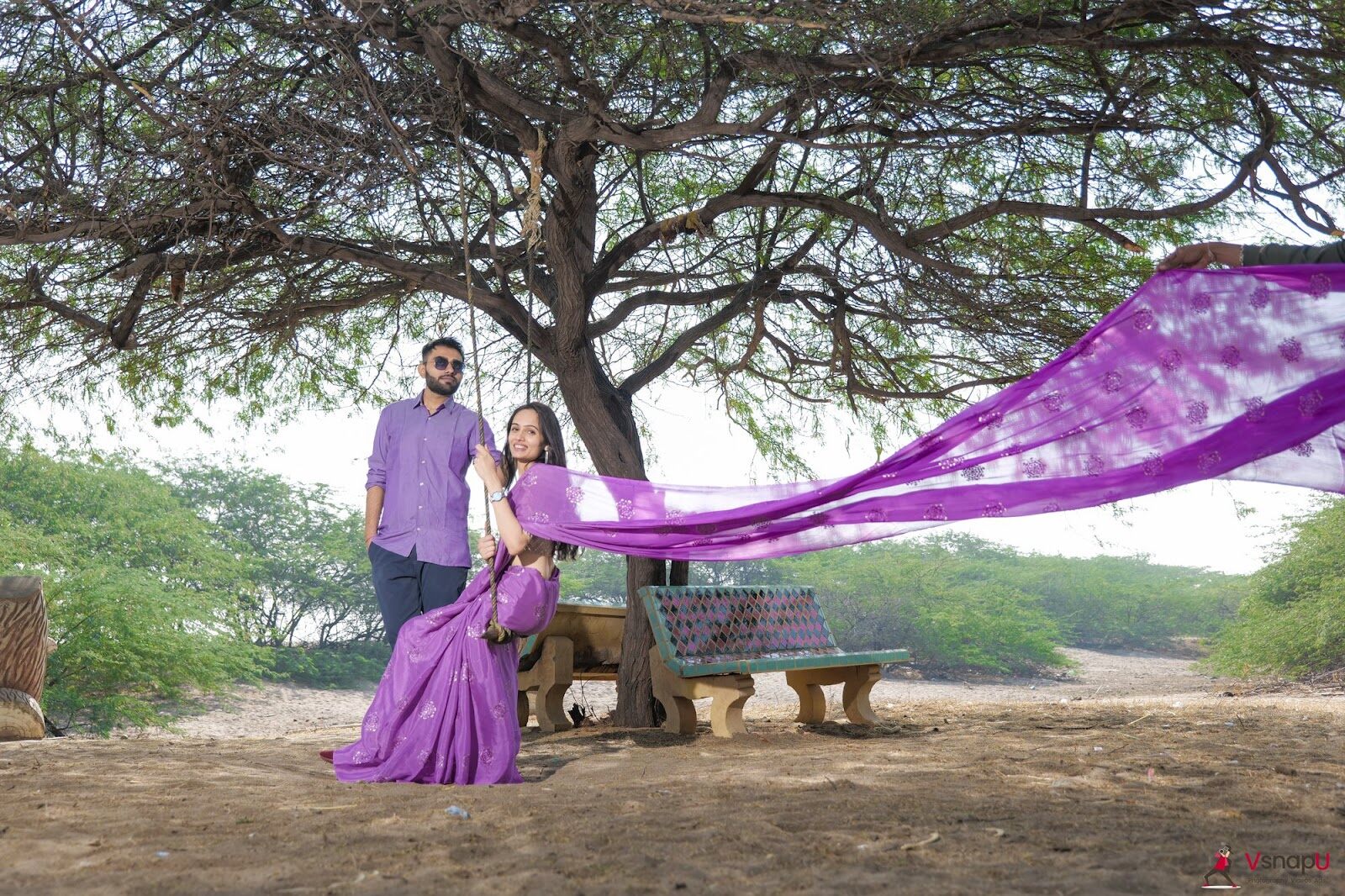 Romantic pre-wedding photoshoot with a couple sharing a kiss at a traditional palace, bride in saree