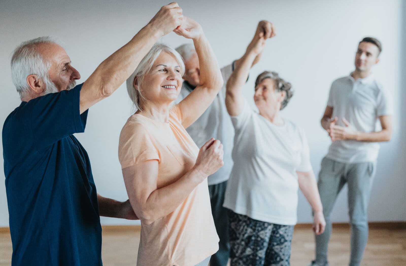 A group of older adults in senior living trying ballroom dancing as a cardio workout.