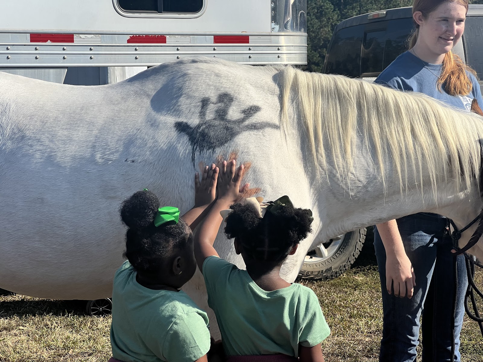 two girls petting a horse