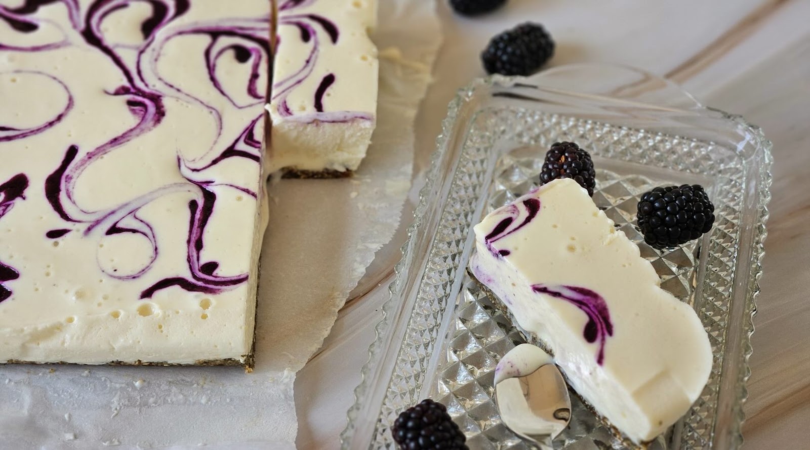  Cottage Cheese Cheesecake Bars Created by a Registered Dietitian on a Glass Plate with Blackberries