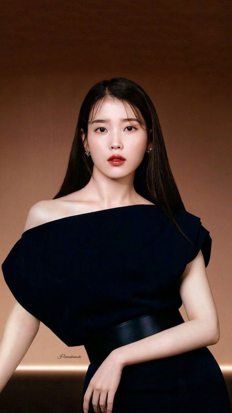 This contains an image of  IU on a black dress