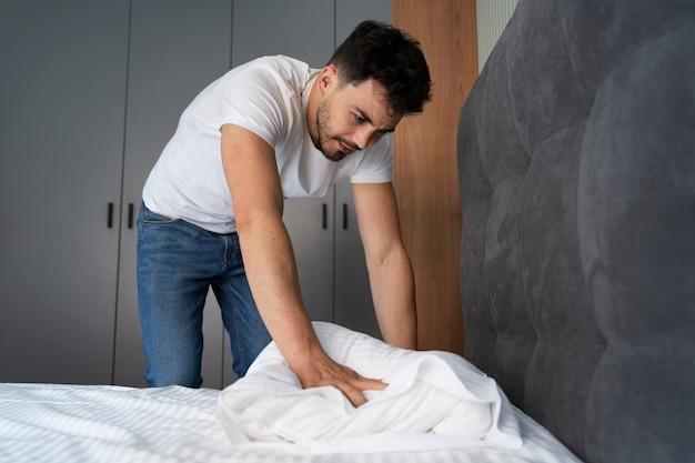 A person folding a bed