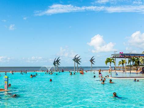 A large pool with people swimming in it

AI-generated content may be incorrect.