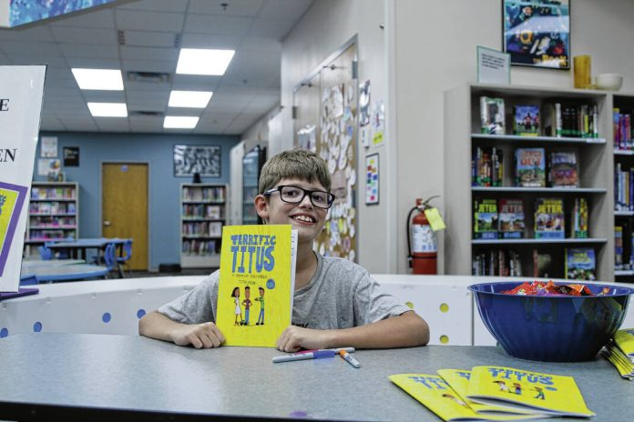 Titus Ehlen with his pubslished graphic novel