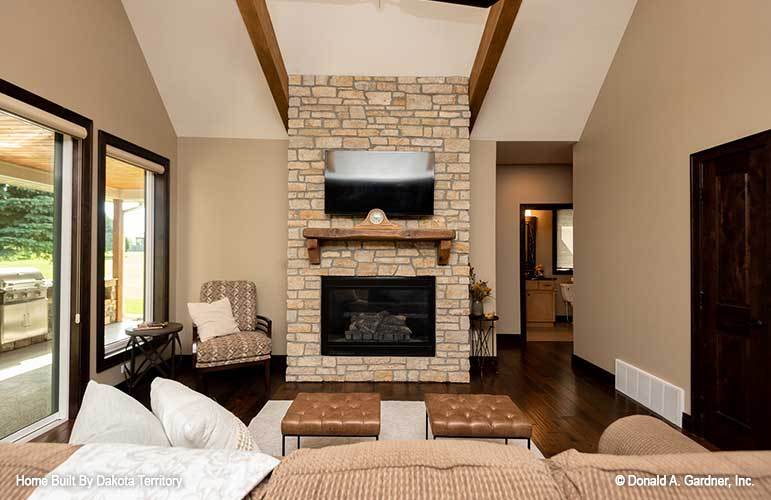 A vaulted ceiling with exposed wood beams topped the living room.A vaulted ceiling with exposed wood beams topped the living room.