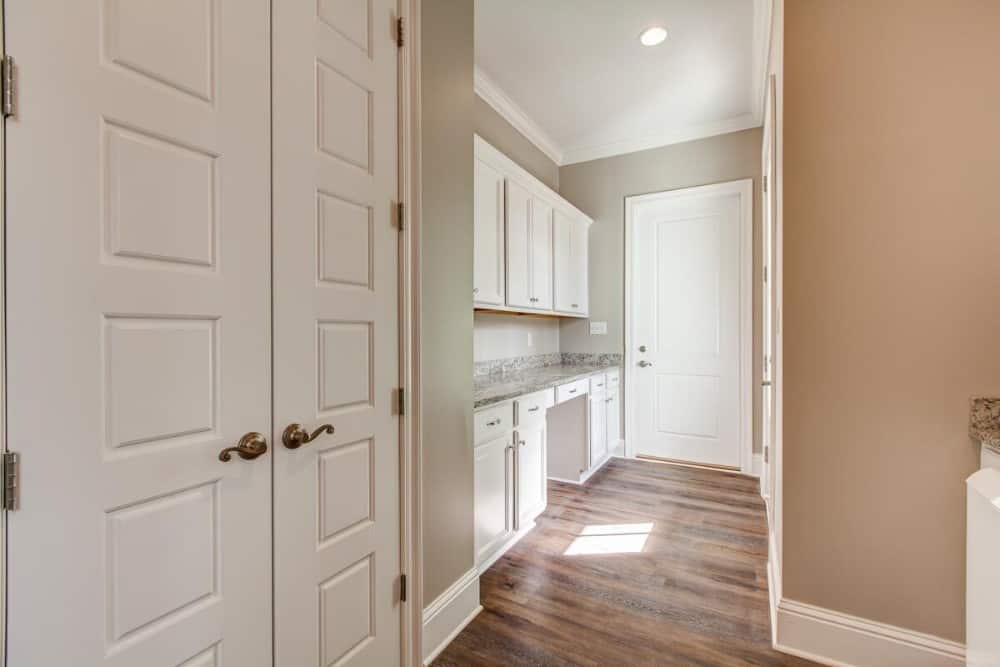 The laundry room includes a storage closet and a built-in counter.