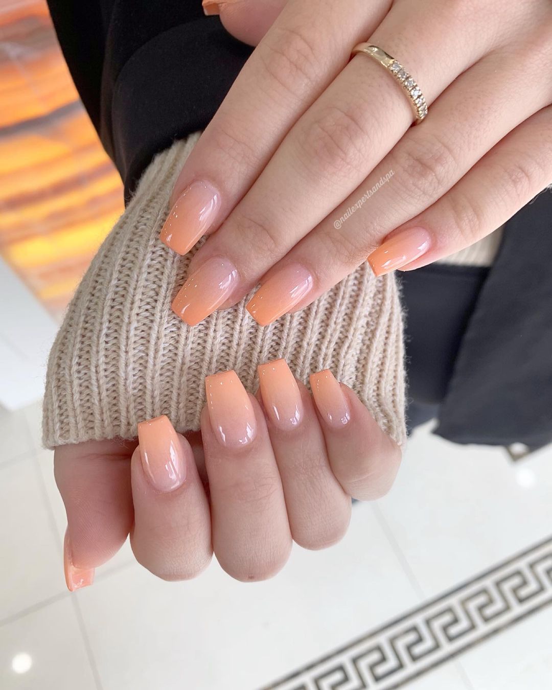 Close up of nails with glittery orange nails having Office-Friendly Orange Nails