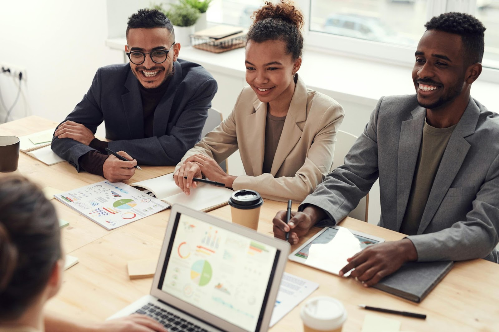 Multicultural professional businesspeople working together on employee allowance typeswith Tax implications in boardroom 