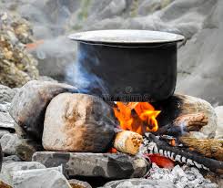 stones and logs of woods used as a set up to cook food in the forest as one of the A tin can designed  into a stove used as emergency cooking Hacks When camping