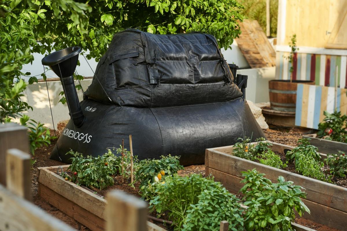 A photo of a Homebiogas' DIY biogas system in a garden. 