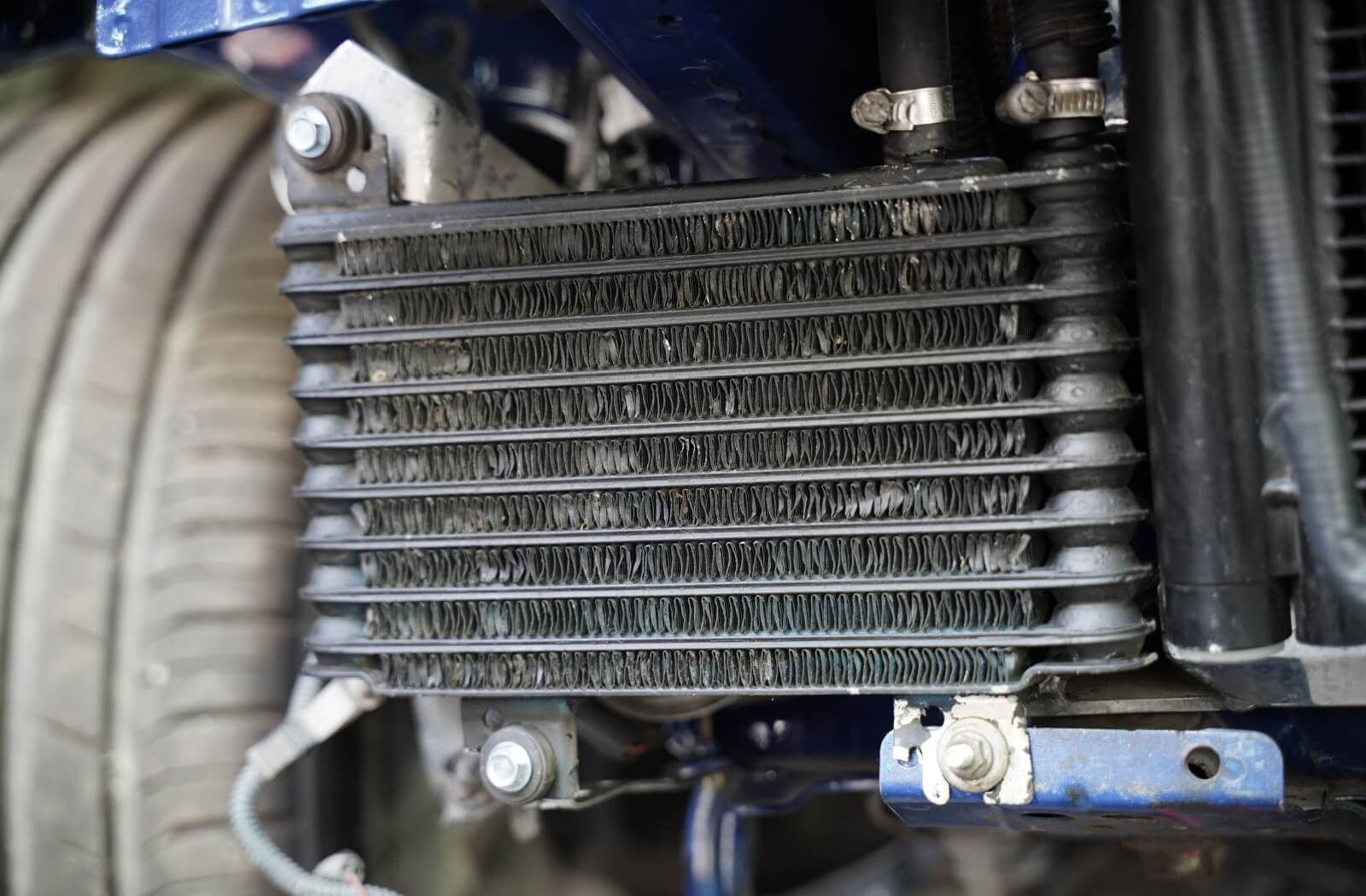 A close-up image of a water cooled oil cooler in a performance vehicle.