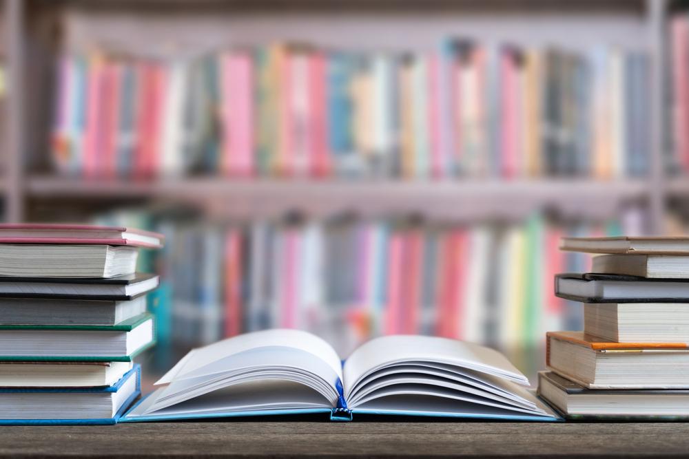 A stack of books on a table

Description automatically generated