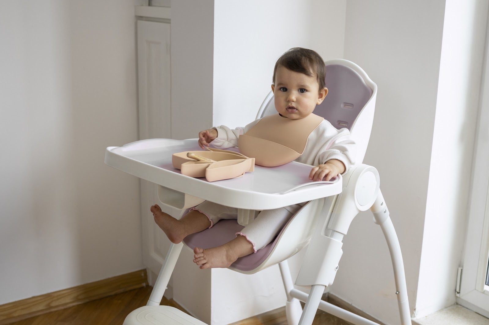 A little girl sitting on her high chair