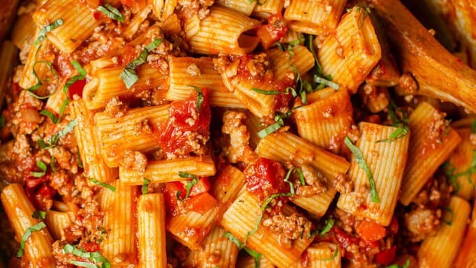 Rigatoni Bolognese in a cooking pot.