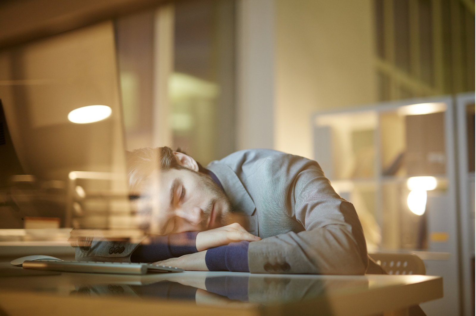 A picture of a person enjoying a coffee nap at office.