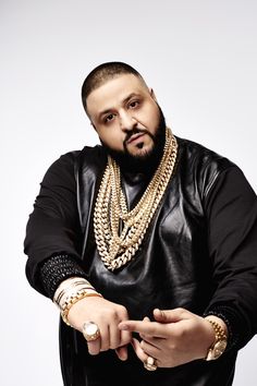 This contains an image of DJ Khaled in black and he is also putting on neck chains and wristwatch 