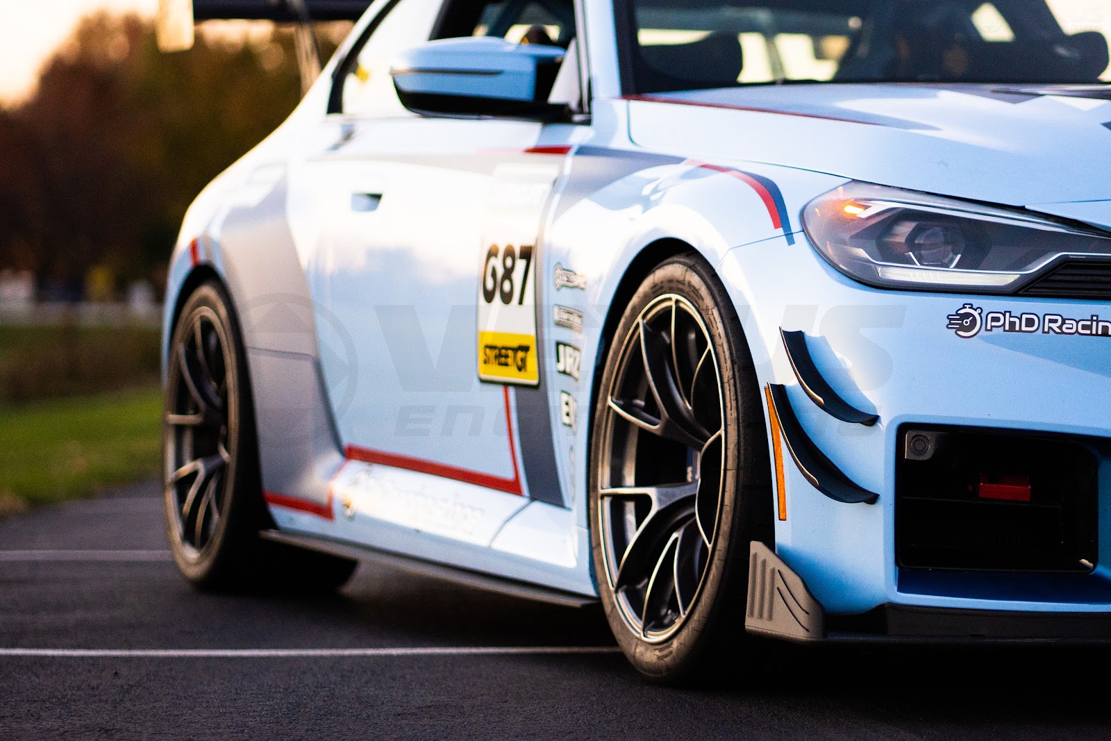 BMW M2 with front splitter end plates positioned in front of the tire.