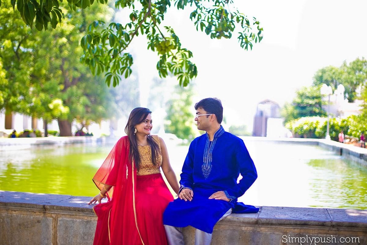 Charming pre-wedding photoshoot of a couple sitting by Ameenpur Lake, lost in each other's gaze