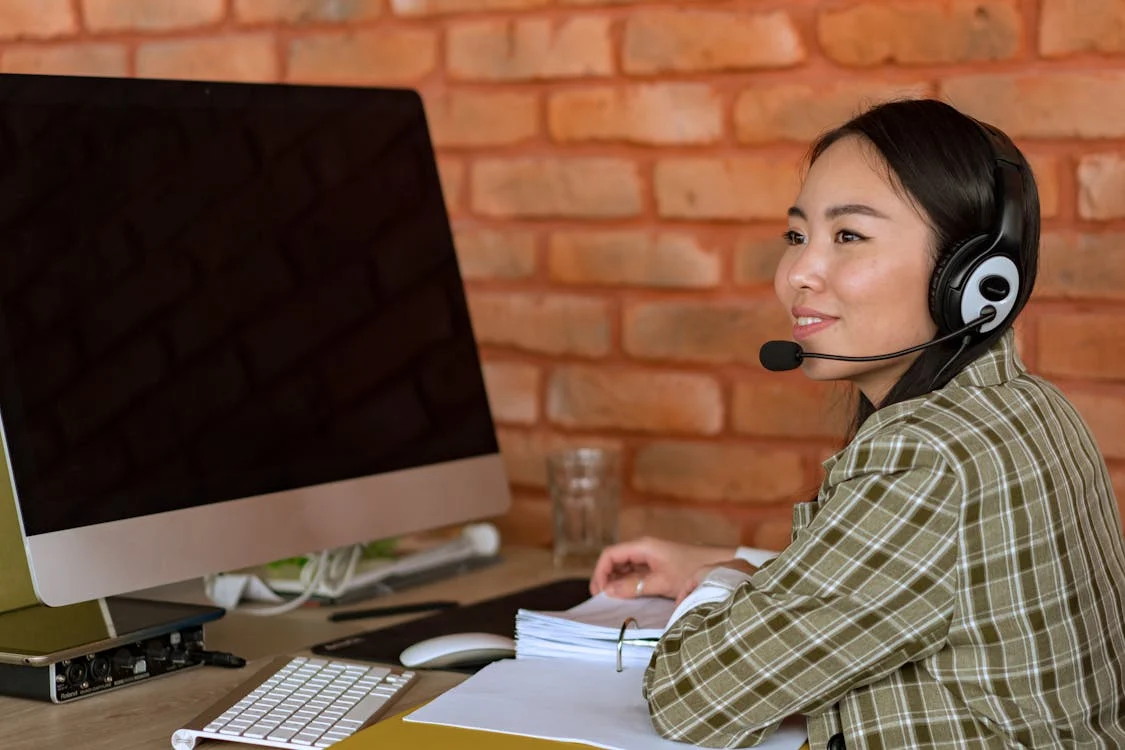 woman in plaid long sleeves sitting inside the office