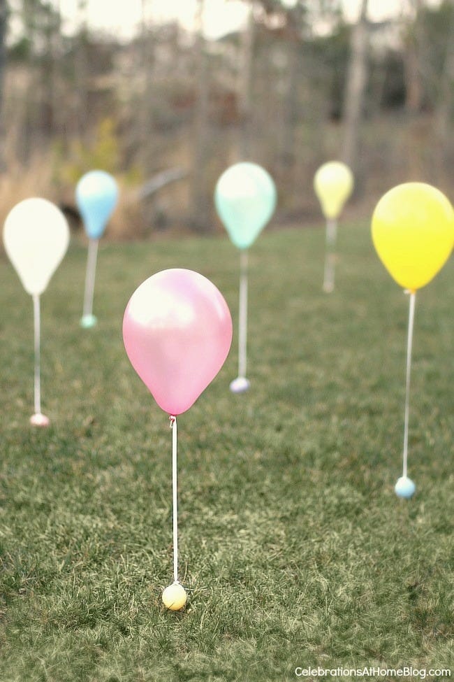 easter egg hunt ideas, balloons tied to eggs outside