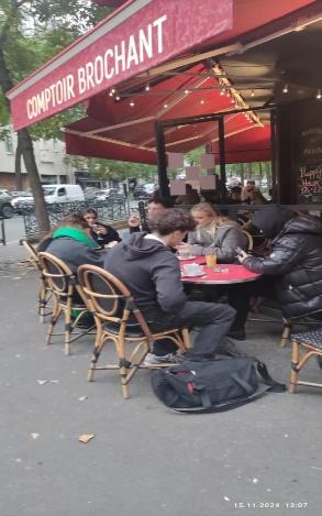 A group of people sitting at a table outsideDescription automatically generated