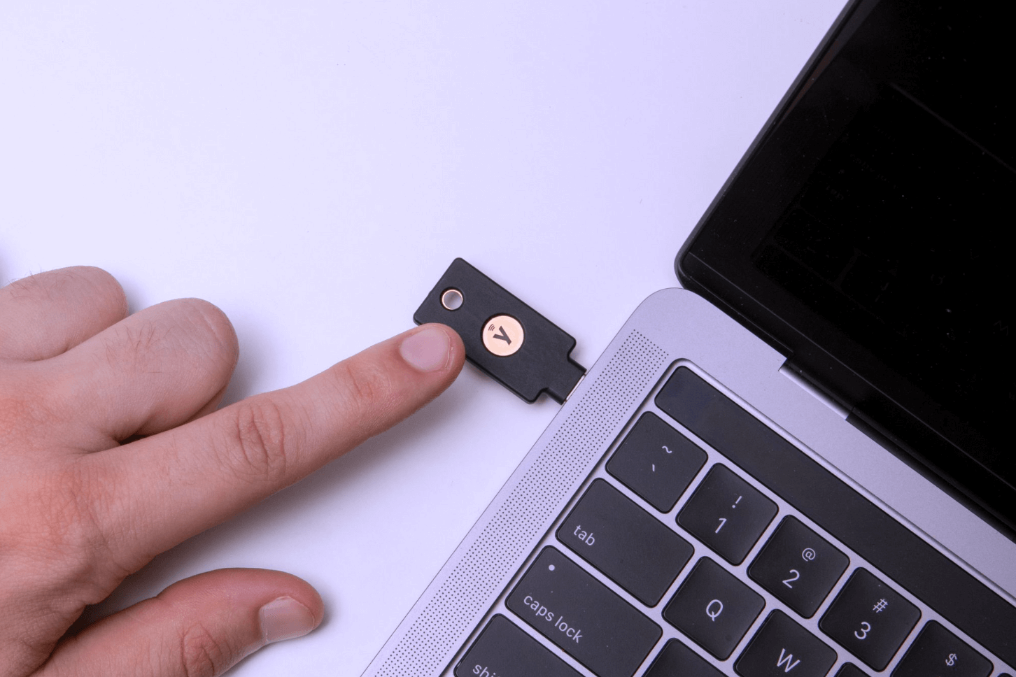 finger-tapping-yubikey-in-laptop