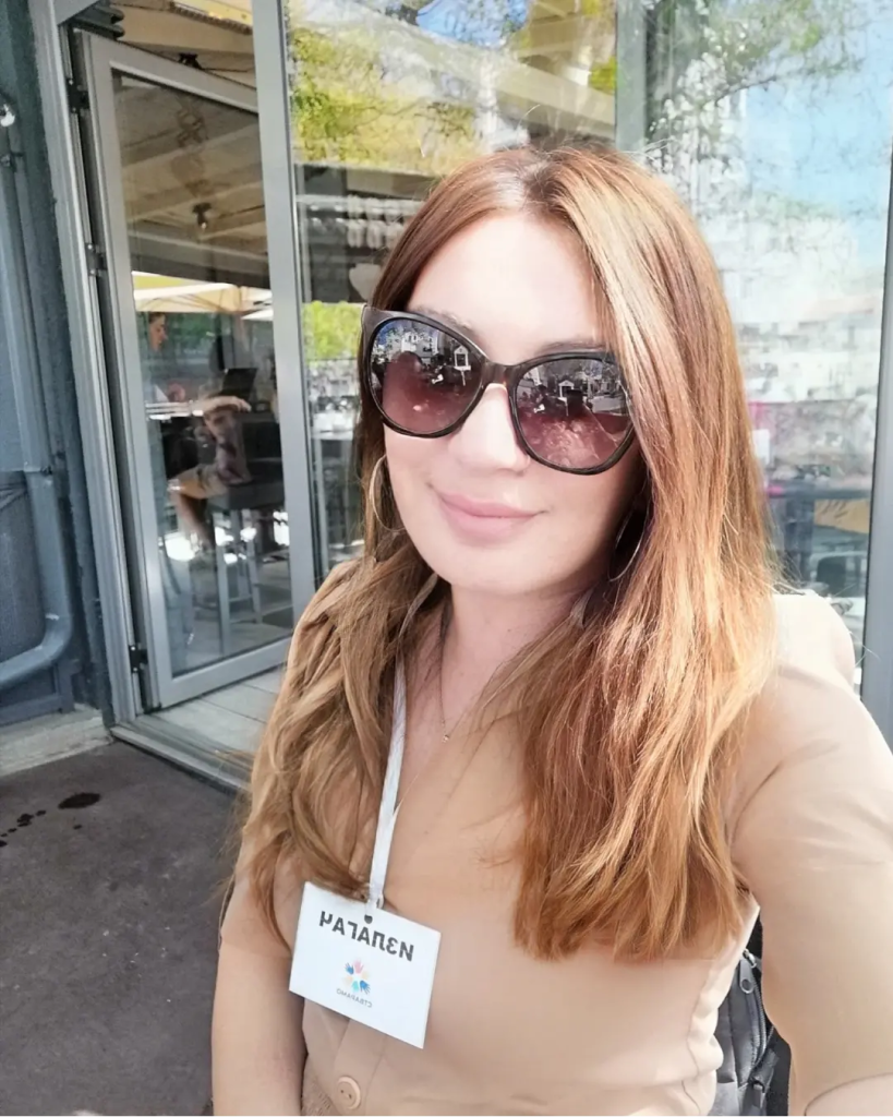 A person wearing sunglasses and a name tag

Description automatically generated