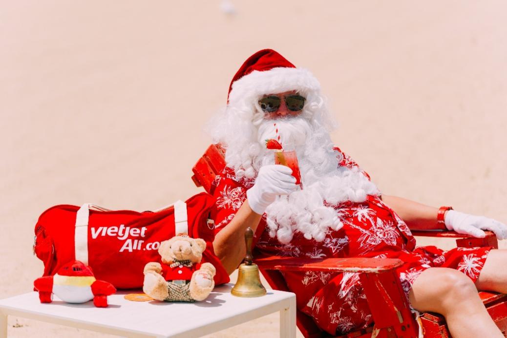 A person in a santa garment drinking a drink Description automatically generated