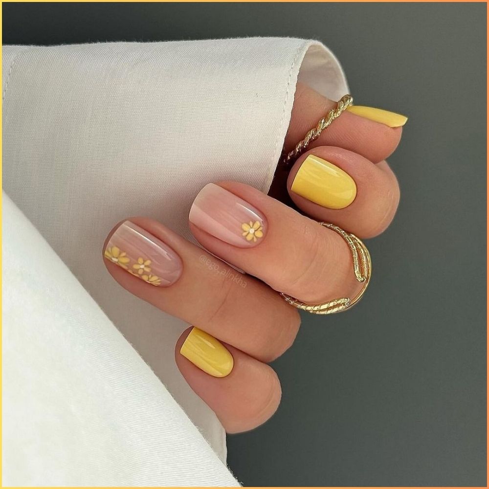 Close up of flowered short nail design with Yellow and Nude Nail Art