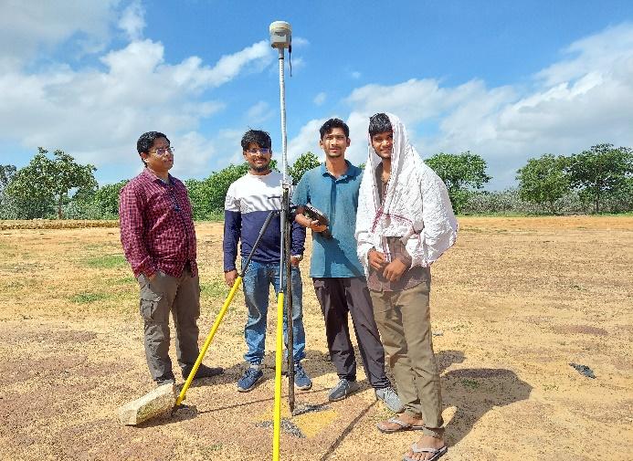 A group of men standing in a field

Description automatically generated