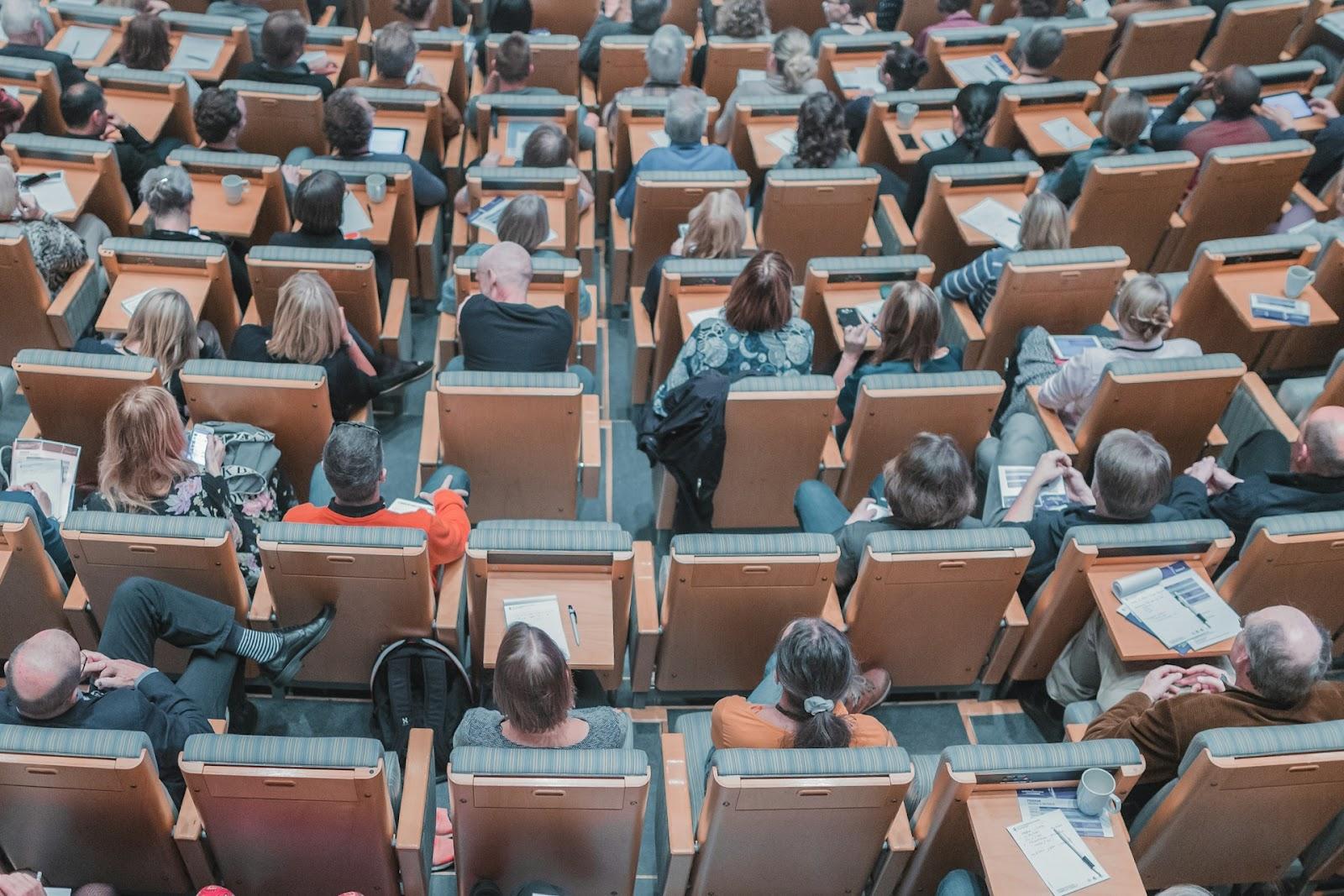 people sitting in a large hall