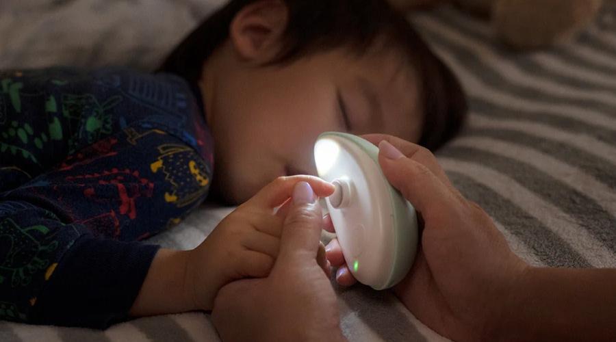 A child sleeping with a light on the finger

AI-generated content may be incorrect.