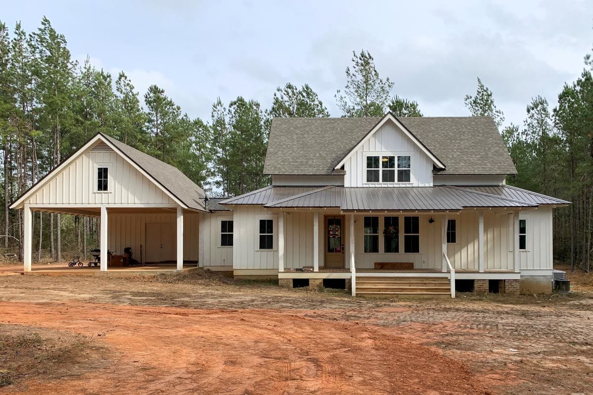 A farther view shows the carport bordered by white columns.