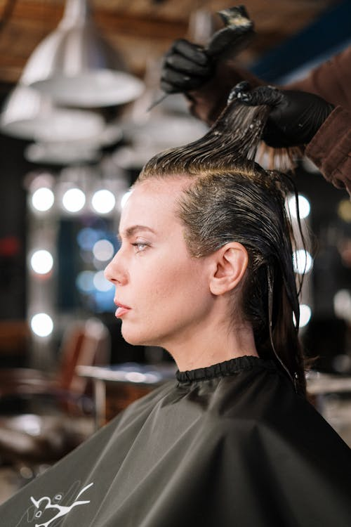 Woman Getting Her Hair Straightened in Salon