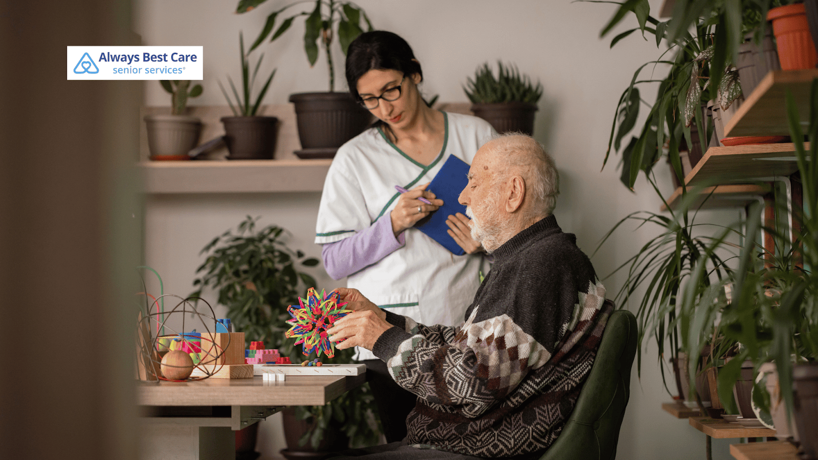 This image depicts a caregiver helping a senior man with a hobby