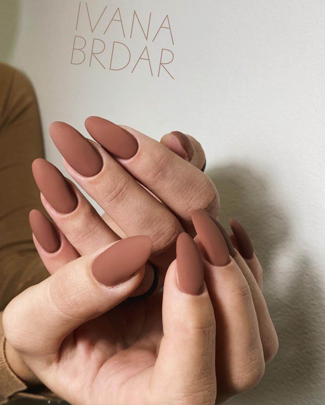 Close-up of hands with fall nail design having Velvet-Effect Nails